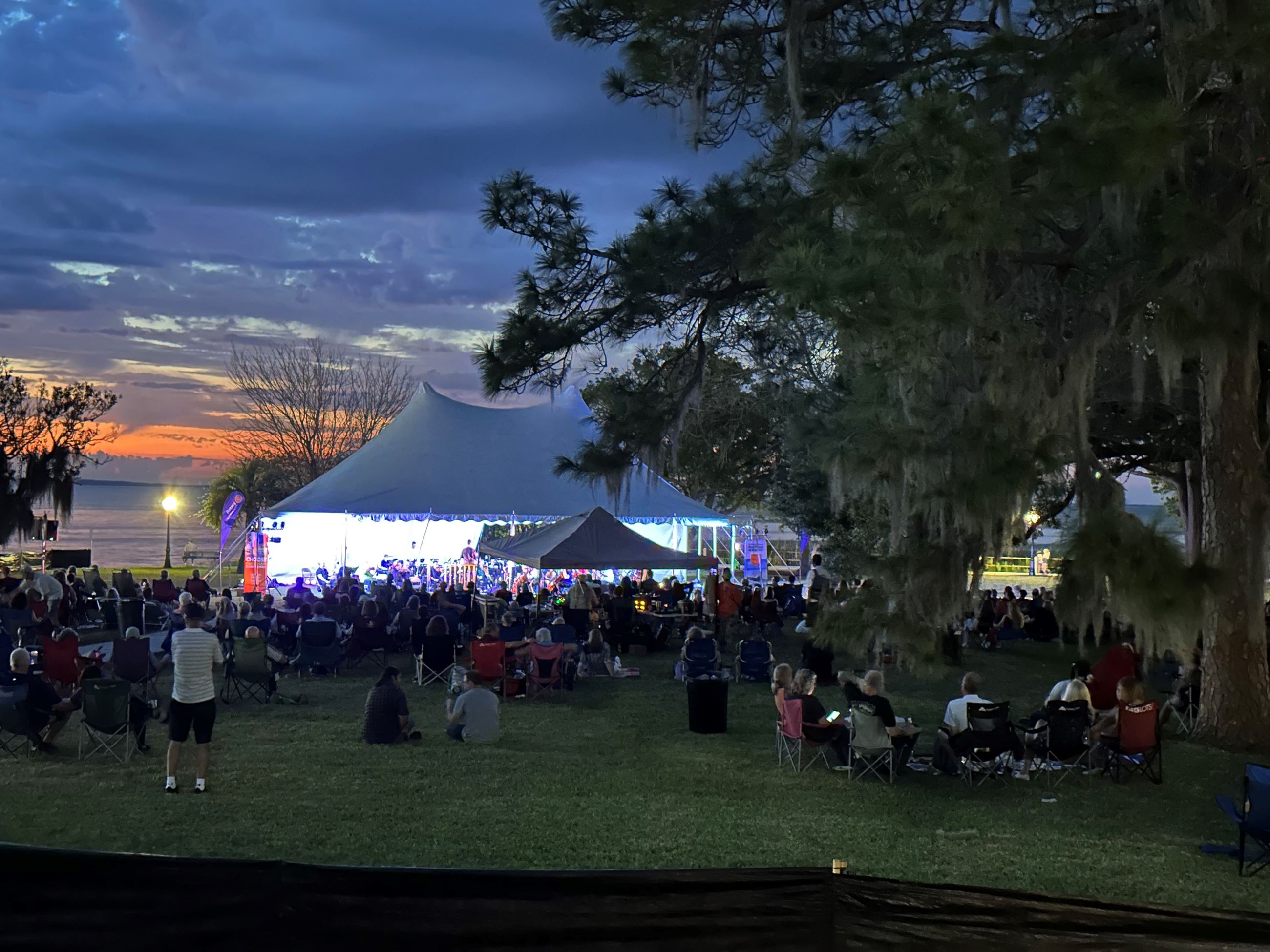 Orchestra under tent on shore of Lake Apopka for Evening at the Pops